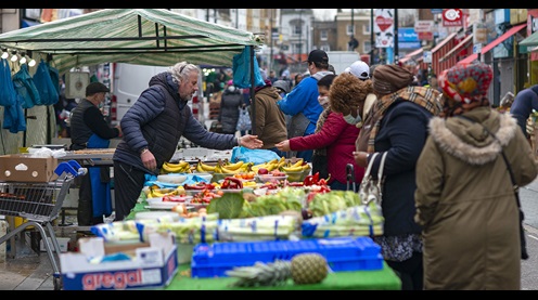 Picture of a busy, bustling market in Lewisham. A market stall selling