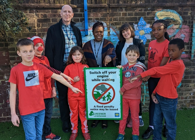 Cllr Sophie McGeevor, Cllr Luke Sorba, Mrs Shermane Okorodudu, headteacher at John Stainer Primary School, and pupils from John Stainer Primary School with anti-idling signage saying "switch your engines off"
