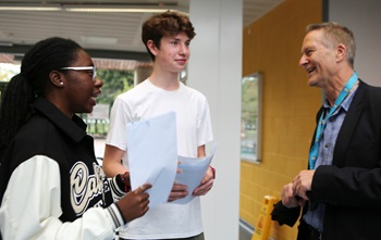 Cllr Barnham at Deptford Green School with two students discussing their results
