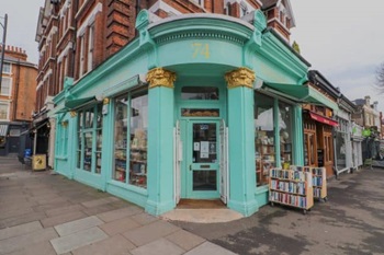 The Bookshop on the heath from the pavement is a corner shop with a turquoise facade