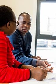 A teacher explaining something to a learner.