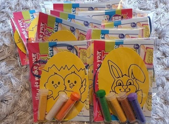 Multiple packs of sand art kits with glitter tubes and easter-themed templates.
