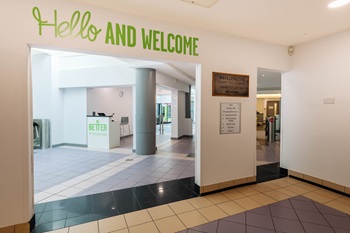 Entrance lobby at Wavelengths leisure centre. A sign reads 'Hello and welcome'.