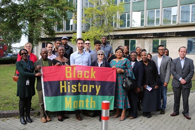 Damien Egan (front, fourth from left), Barbara Gray (front, third from left) and Cllr Jonathan Slater (far right) with councillors and Lewisham Council employees at the Black History Month flag raising in Catford.