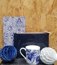 Blue and white cup, blue makeup bag, blue and white notebook