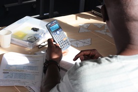 A learner working on a calculator.
