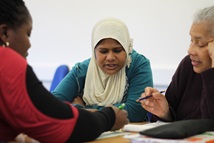 Three women working on a maths problem.