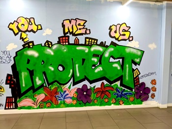 'You, me, us, protect' painted on an inside wall