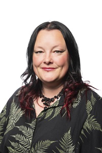 A woman smiles at the camera