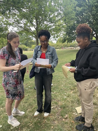 Three Alevel students reading their A level results
