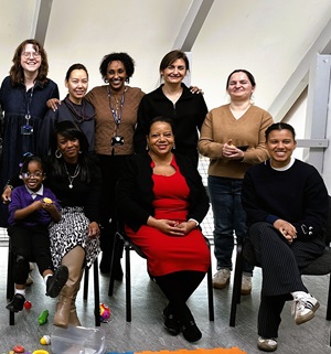 A group of women smile at the camera in The Albany theatre cafe