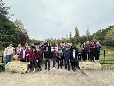 a group of children stand at the entrance of Northbrook park