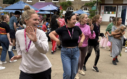 People dance together in a line 