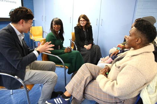 Debbie Weekes-Bernard, Cllr Edison Huynh, Diana Johnson MP speaking with staff member