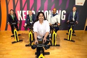 Five people sit on spin bikes in the Forest Hill pools centre