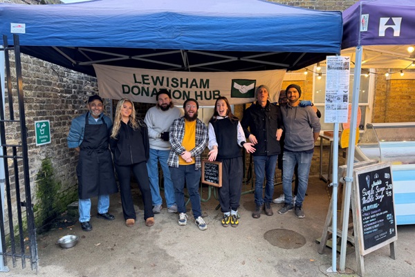 Group of staff standing under Lewisham Donation Hub gazebo