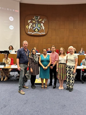 A group of people stand in Lewisham council chamber