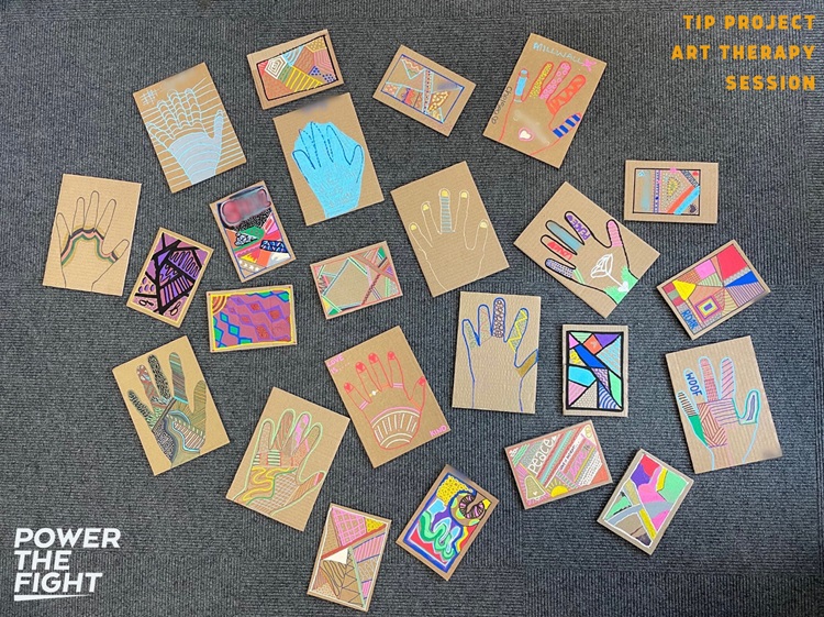 A collection of painted cards with different patterns and outlines of hands. It is labelled Tip Project Art Therapy Session in the top right corner and Power The Fight in the bottom left corner.