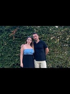 Foster carers Yeliz and Erkan standing in a garden 