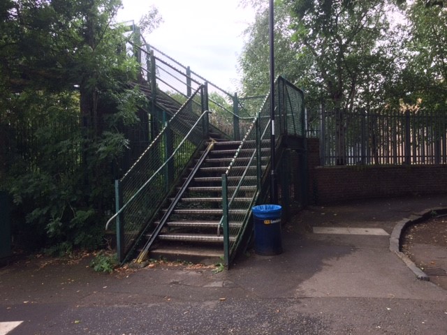 The stairs leading up to Sydenham Park Footbridge, with trees around them
