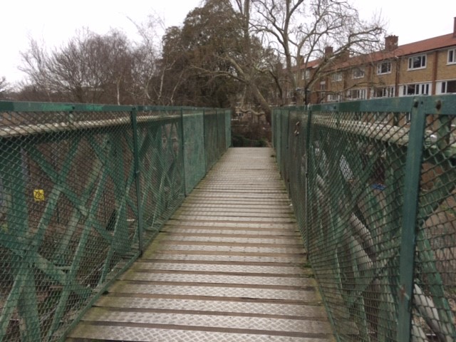 The main part of the Sydenham Park Footbridge, with trees and houses in the background
