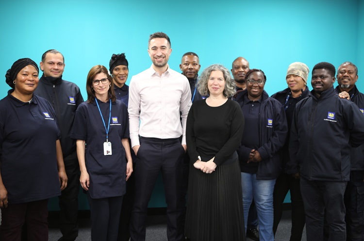 A group of staff in Lewisham cleaning uniforms with the Mayor of Lewisham and Councillor Amanda de Ryk