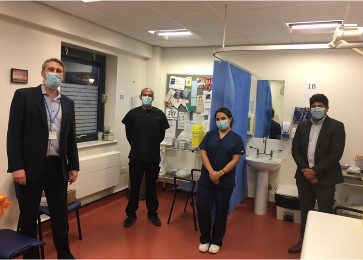 Martin Wilkinson, Director of Integrated Care and Commissioning, Lewisham at South East London CCG with the local doctor and team delivering the first vaccinations